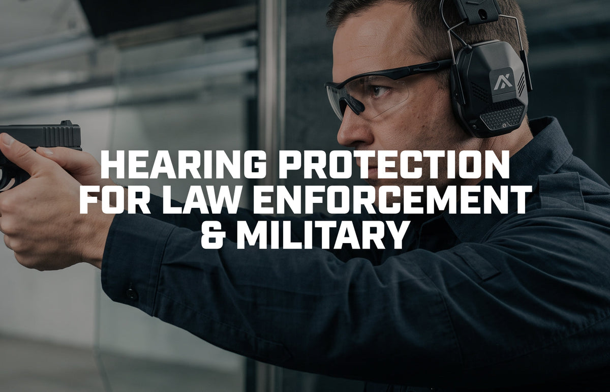 Officer on an indoor range line wearing electronic earmuffs and eye protection